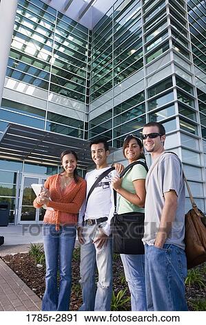 College students standing in front of a building View Large Photo Image Stock Image - College students standing in front of a building. Fotosearch