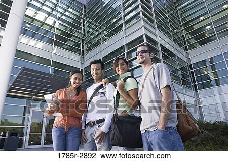 College students standing in front of a building View Large Photo Image Stock Image - College students standing in front of a building. Fotosearch