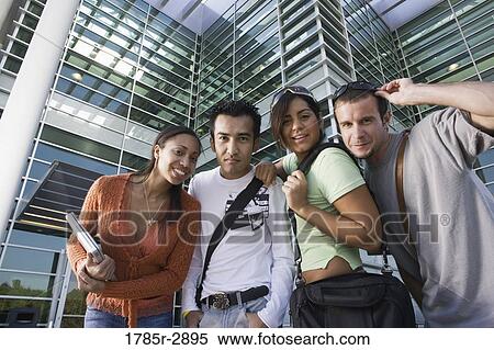 Stock Photography - College students standing in front of a building. Fotosearch