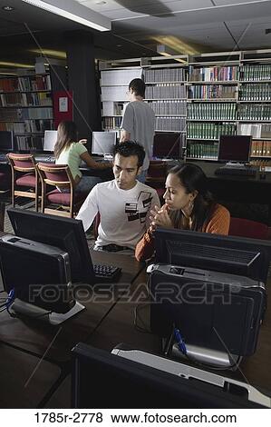 College students using computers in the library View Large Photo Image Stock Photo - College students using computers in the library. Fotosearch