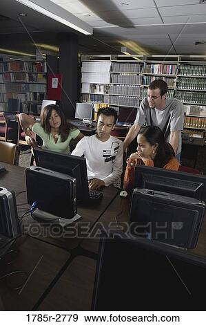 Stock Photo - College students using computers in the library. Fotosearch