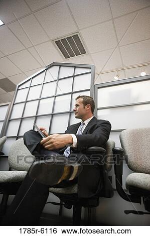 Contemplative businessman seated in a waiting room View Large Photo Image Stock Photograph - Contemplative businessman seated in a waiting room. Fotosearch
