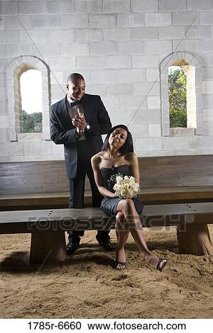 Stock Image - Couple in formal attire inside a medieval castle. Fotosearch