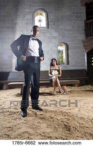 Stock Image - Couple in formal attire inside a medieval castle. Fotosearch