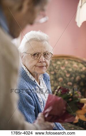 Elderly man offering gift to angry wife View Large Photo Image Picture - Elderly man offering gift to angry wife. Fotosearch