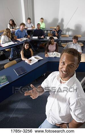 Elevated view of a teacher and students in the classroom View Large Photo Image Stock Photograph - Elevated view of a teacher and students in the classroom. Fotosearch