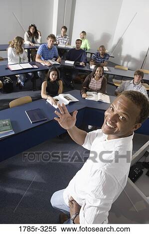 Elevated view of a teacher and students in the classroom View Large Photo Image Stock Photography - Elevated view of a teacher and students in the classroom. Fotosearch