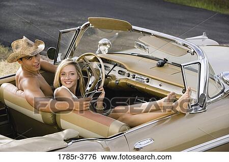 Elevated view of a young couple sitting in antique convertible car View Large Photo Image Stock Photograph - Elevated view of a young couple sitting in antique convertible car. Fotosearch