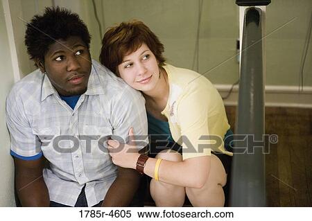Elevated view of a young inter-racial couple sitting together View Large Photo Image Stock Photography - Elevated view of a young inter-racial couple sitting together. Fotosearch