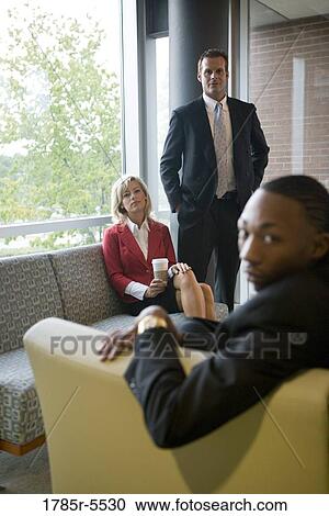 Elevated view of business people sitting and waiting in an office lounge area View Large Photo Image Stock Image - Elevated view of business people sitting and waiting in an office lounge area. Fotosearch