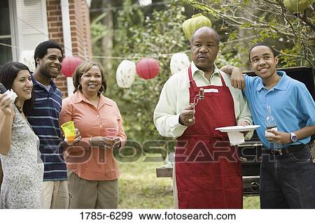 Family and friends at backyard cookout View Large Photo Image Stock Photo - Family and friends at backyard cookout. Fotosearch
