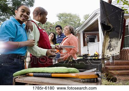 Family and friends enjoying backyard cookout View Large Photo Image Stock Image - Family and friends enjoying backyard cookout. Fotosearch