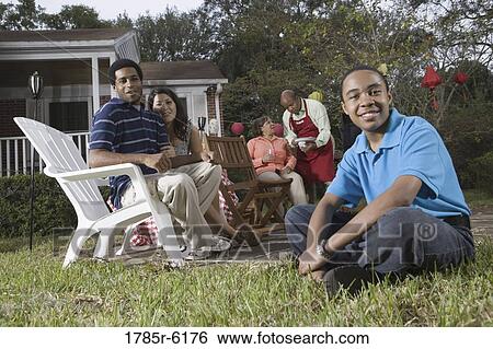 Family and friends enjoying backyard cookout View Large Photo Image Stock Photograph - Family and friends enjoying backyard cookout. Fotosearch