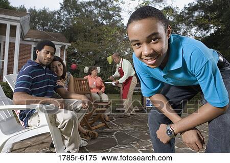 Family and friends enjoying backyard cookout View Large Photo Image Stock Photography - Family and friends enjoying backyard cookout. Fotosearch