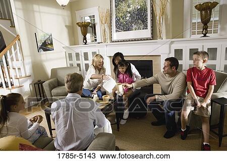 Family and friends having breakfast together in living room View Large Photo Image Stock Image - Family and friends having breakfast together in living room. Fotosearch