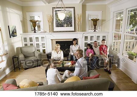 Family and friends together in living room View Large Photo Image Stock Image - Family and friends together in living room. Fotosearch