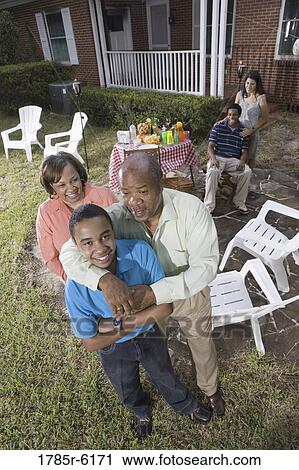 Family enjoying a backyard barbeque View Large Photo Image Stock Image - Family enjoying a backyard barbeque. Fotosearch