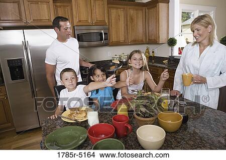 Family having breakfast in the kitchen View Large Photo Image Picture - Family having breakfast in the kitchen. Fotosearch