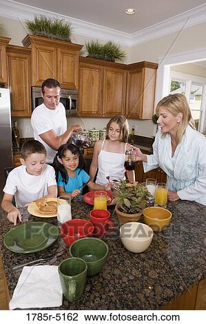 Family having breakfast in the kitchen View Large Photo Image Stock Image - Family having breakfast in the kitchen. Fotosearch