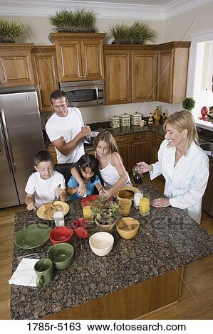 Family having breakfast in the kitchen View Large Photo Image Stock Image - Family having breakfast in the kitchen. Fotosearch