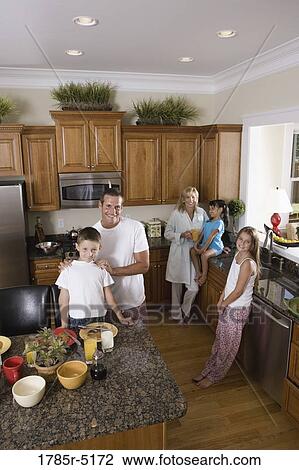 Family having breakfast in the kitchen View Large Photo Image Stock Image - Family having breakfast in the kitchen. Fotosearch