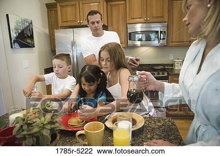 Family having breakfast in the kitchen View Large Photo Image Stock Image - Family having breakfast in the kitchen. Fotosearch