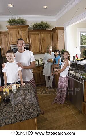 Family having breakfast in the kitchen View Large Photo Image Stock Photo - Family having breakfast in the kitchen. Fotosearch