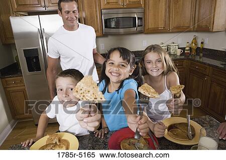 Stock Photography - Family having breakfast in the kitchen. Fotosearch