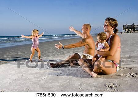 Family having fun at the beach View Large Photo Image Stock Image - Family having fun at the beach. Fotosearch