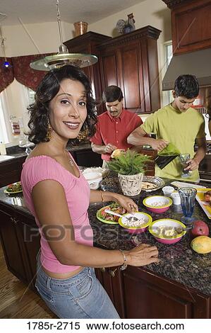 Family in the kitchen with mother preparing food View Large Photo Image Stock Photography - Family in the kitchen with mother preparing food. Fotosearch