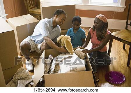 Family packing or unpacking moving box View Large Photo Image Picture - Family packing or unpacking moving box. Fotosearch