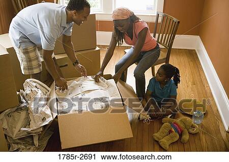 Family packing or unpacking moving box View Large Photo Image Stock Image - Family packing or unpacking moving box. Fotosearch