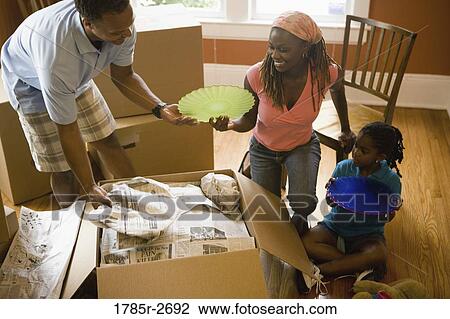 Family packing or unpacking moving box View Large Photo Image Stock Image - Family packing or unpacking moving box. Fotosearch