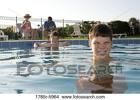Family vacation at a swimming pool View Large Photo Image Picture - Family vacation at a swimming pool. Fotosearch