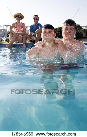 Family vacation at a swimming pool View Large Photo Image Stock Photo - Family vacation at a swimming pool. Fotosearch