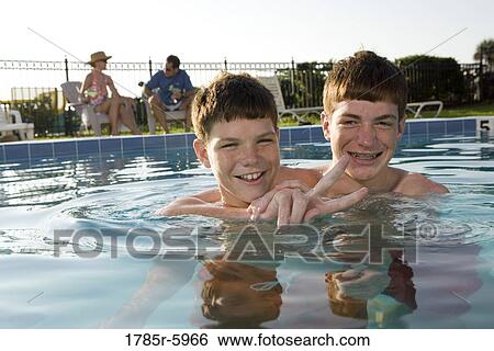 Family vacation at a swimming pool View Large Photo Image Stock Photograph - Family vacation at a swimming pool. Fotosearch