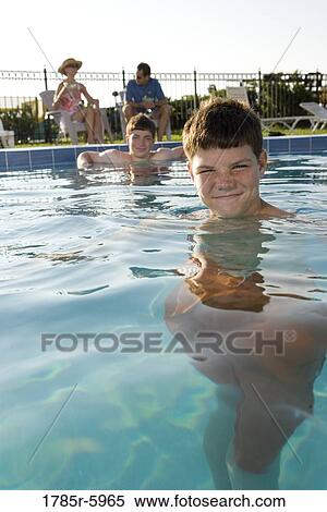 Family vacation at a swimming pool View Large Photo Image Stock Photography - Family vacation at a swimming pool. Fotosearch