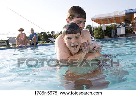 Family vacation at a swimming pool View Large Photo Image Stock Photography - Family vacation at a swimming pool. Fotosearch