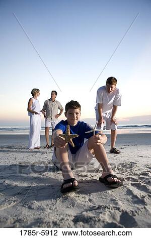 Stock Image - Family vacation at the beach. Fotosearch
