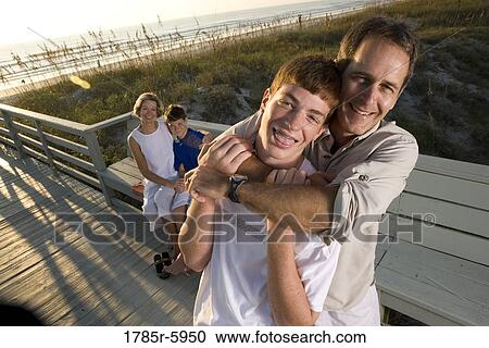 Stock Image - Family vacation at the beach. Fotosearch