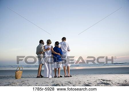 Stock Photo - Family vacation at the beach. Fotosearch