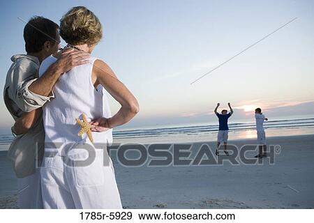 Stock Photo - Family vacation at the beach. Fotosearch