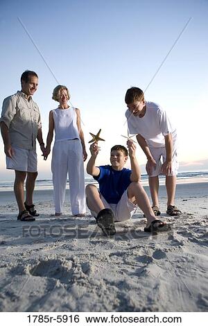 Stock Photograph - Family vacation at the beach. Fotosearch