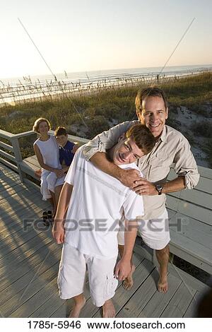 Stock Photograph - Family vacation at the beach. Fotosearch