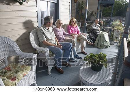 Family with elderly parents and adult children sitting together on front porch View Large Photo Image Stock Image - Family with elderly parents and adult children sitting together on front porch. Fotosearch