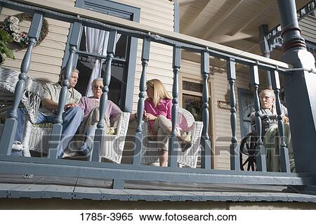 Family with elderly parents and adult children sitting together on front porch View Large Photo Image Stock Photography - Family with elderly parents and adult children sitting together on front porch. Fotosearch