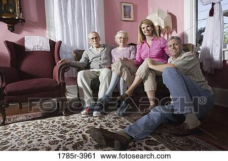 Family with senior parents and adult children sitting together in a living room View Large Photo Image Stock Image - Family with senior parents and adult children sitting together in a living room. Fotosearch