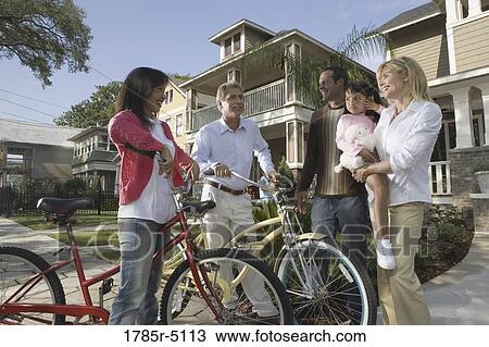 Family with young child conversing with neighbors in front of house View Large Photo Image Stock Image - Family with young child conversing with neighbors in front of house. Fotosearch