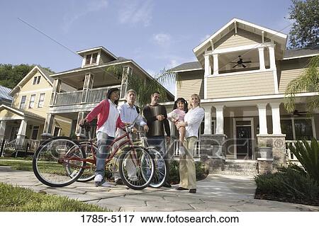 Family with young child conversing with neighbors in front of house View Large Photo Image Stock Photo - Family with young child conversing with neighbors in front of house. Fotosearch
