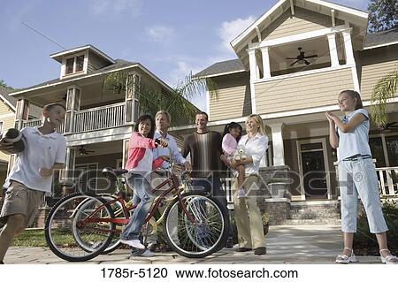 Family with young children conversing with neighbors in front of house View Large Photo Image Stock Image - Family with young children conversing with neighbors in front of house. Fotosearch